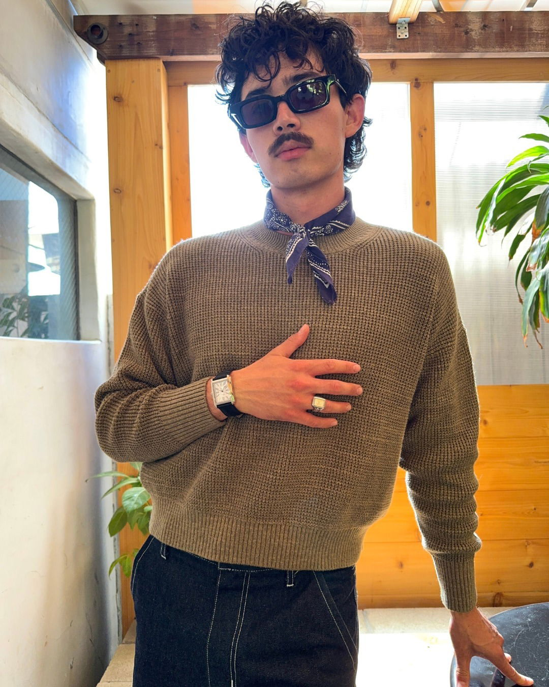 Photo shared by Fossil on July 25, 2024 tagging @bigceasars. May be an image of 1 person, eyewear, sweater, bolo tie, bandanna, turtleneck and text.