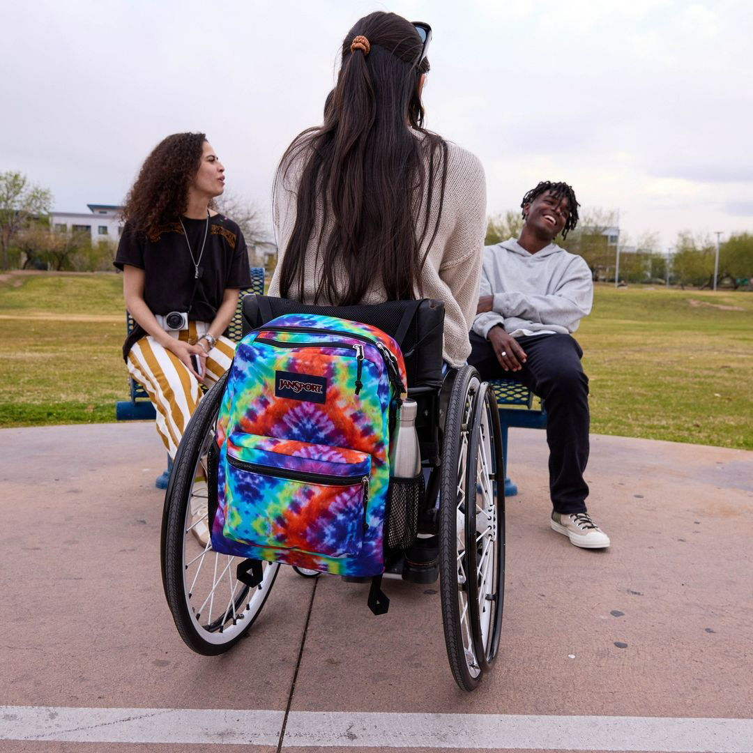 Photo by JanSport on July 25, 2024. May be an image of 3 people, wheelchair, wheel and text.
